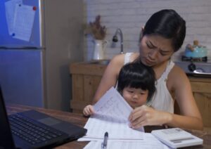 mother and child looking through financial documents